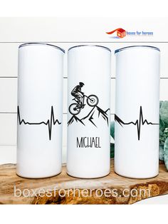 three white tumblers with the words michael on them and a mountain bike in the middle