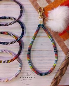 the beaded dog leash is on display next to other beads and a white pom - pom