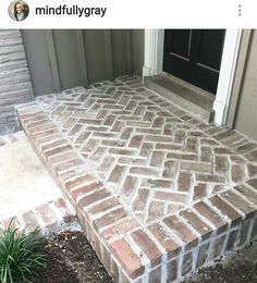 a brick walkway in front of a door