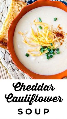 a bowl of cheddar cauliflower soup with bread on the side and text overlay reading cheddar cauliflower soup