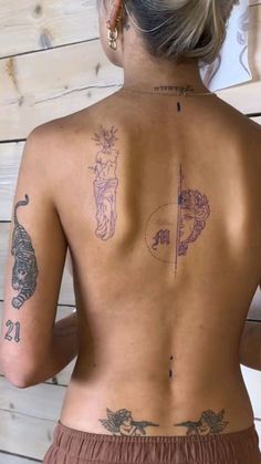 the back of a woman with tattoos on her body