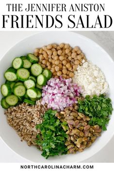 a white bowl filled with beans, cucumbers and other ingredients to make a salad