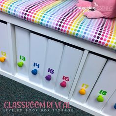 the drawers have numbers on them and are painted with polka - dot fabric, as well as colored balls