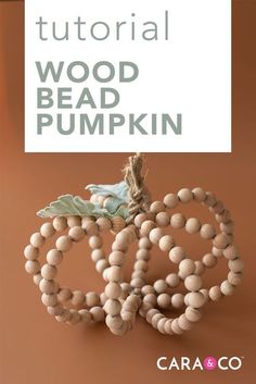 a wooden bead pumpkin sitting on top of a table