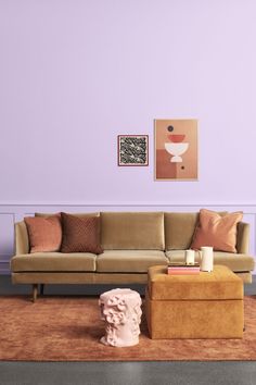 a living room with purple walls and furniture