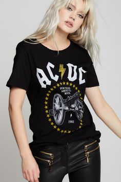 Get ready to rock with AC/DC! "For Those About To Rock" is an iconic AC/DC hit from their 1980 movie, "Live at Donington". This dark and edgy tee features artwork from the album cover in white and yellow. Our relaxed boyfriend tee is made with soft cotton fabric, distressed edges, a raw cut bottom hem, and a loose crew neckline. Details Style #301294 Color: Black AC/DC “For Those About To Rock” Cannon Boyfriend T-Shirt Keyword: ACDC 100% Cotton Care/Import Machine Wash Cold, Tumble Dry Low Desig Rock Style T-shirt With Band Logo For Music Festivals, Rock And Roll Band Logo T-shirt For Fans, Rock Style Band Logo T-shirt For Streetwear, Rocker Style Fan Merchandise Tops For Summer, Rock Style Graphic T-shirt For Streetwear, Rock Style Graphic Print T-shirt For Streetwear, Rock And Roll Band Logo T-shirt For Music Festivals, Rock And Roll Band Logo T-shirt For Streetwear, Rocker Style Band Logo T-shirt For Summer