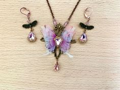 a necklace and earring set with butterfly charms