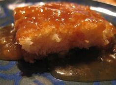 a piece of cake sitting on top of a blue and white plate covered in jelly