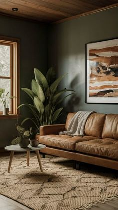 a living room filled with furniture and a painting on the wall