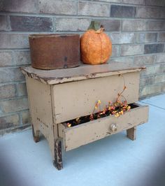 an old wooden box sitting on top of a blue floor next to a brick wall