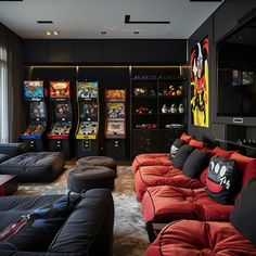 a living room filled with black couches and arcade machines in the wall behind them