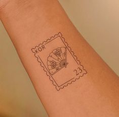 a stamp with an image of a fan on it's left arm and the word nor written in black ink