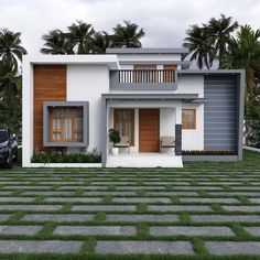 a car parked in front of a two story house with palm trees on the other side