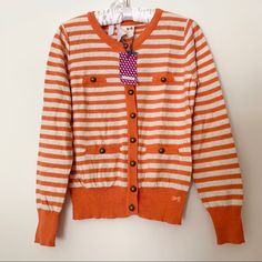 Cute Tommygirl Cardigan Striped Orange And White. Has Buttons Along The Front And Pockets. Cute Cotton Cardigan With Button Closure, Cotton Cardigan With Button Closure, Cute Style, Striped Long Sleeve Cotton Cardigan, Cute Cotton Sweater With Buttons, Striped Cotton Long Sleeve Cardigan, Cute Cotton Buttoned Sweater, Striped Cotton Cardigan With Long Sleeves, Preppy White Cardigan For Fall, White Preppy Cardigan For Fall