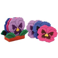 three flower potted plants made out of perler beads on a white background, each with different colored flowers