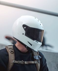 a man wearing a white helmet and suspenders