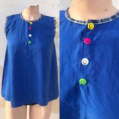 "Cuteness overload! Royal blue lovely tank top with buttoned neckline that features colorful smiley buttons! 🙂🙂 Asymmetrical, loose in A-line made by soft polyester, it also has lovely blue checkered hemlines on sleeves and neckline However, it's such a lovely long blouse and seems to be very cool, ideal for the hot summer days Old school, kawaii, girly to the bone lovely tank top! Matched it with your blue ballerinas for extra cuteness 🤗 ‼️Be aware! only one is available--- 🌀MEASUREMENTS: ( Multicolor Sleeveless Top With Buttons, Blue Sleeveless Tank Top With Button Closure, Cute Sleeveless Buttoned Tops, Playful Summer Tops With Button Closure, Playful Blue Sleeveless Tank Top, Blue Playful Tank Top, Blue Retro Tops With Buttons, Retro Blue Sleeveless Top, Blue Cotton Buttoned Tank Top