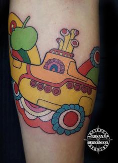 a yellow submarine tattoo on the leg