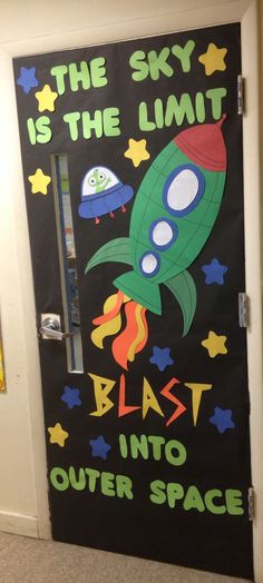 a door decorated with an image of a rocket ship and the words, the sky is the limit blast into outer space