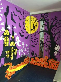 a room decorated in purple and orange with halloween decorations