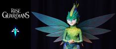 a green and blue fairy with wings standing in front of a black background that says rise of the guardianss