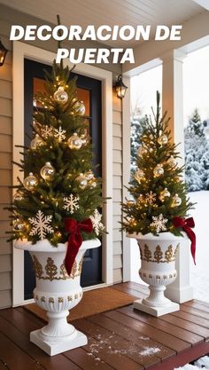 two potted christmas trees sitting on top of a wooden table in front of a house