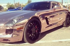 a shiny silver sports car parked in a parking lot