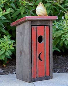 an image of a birdhouse with two birds on it's top and bottom