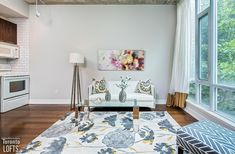 a living room filled with furniture and lots of windows