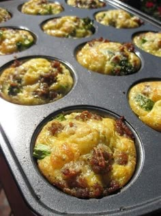 a muffin tin filled with lots of different types of breakfast food in it's tray