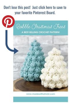 two crocheted christmas trees sitting on top of a wooden table next to each other