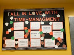 a bulletin board with flowers on it in front of a wall that says fall in love with time - management