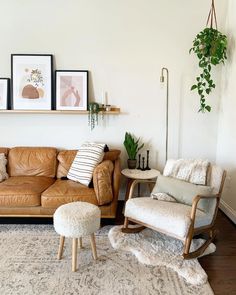 a living room with leather couches and pictures on the wall above them, along with a chair and ottoman