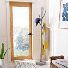 a white room with a door and some towels hanging on the rack next to it