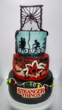 three tiered cake decorated with bicycles and christmas lights