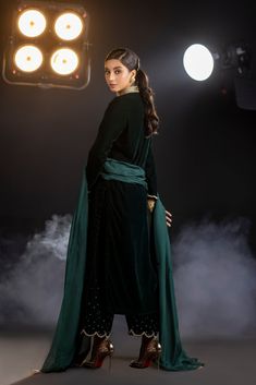 An emerald green velvet outfit with a cut-out embroidered neckline and sparkling embroidered trousers (included) is a striking and glamorous choice that combines rich color, intricate detailing, and a touch of sparkle.  Complete this ethereal look with this luxurious silk dupatta (sold separately) with sparkling sequin Embroidery Suits Design