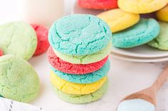 a stack of colorful cookies sitting on top of a white plate