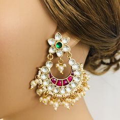 Beautiful and Unique Style Affordable Luxury traditional Bollywood Chandbali earrings with Kundan stones and Colored ruby semi precious Stones. Features: Made in Brass with 22 Karat Gold finish Earrings come with Push back closure Lightweight Jewelry Length: Approx. 2.25 Inches Suitable for any festive occasion and Attire Traditional Indian Chandbali made with Kundan Stones, Ruby and Emerald stones Traditional White Chandbalis With Gota Work, Multicolor Chandbalis With Zari Work For Wedding, Multicolor Cutdana Earrings For Wedding, Multicolor Zari Work Chandbalis For Wedding, Multicolor Cutdana Wedding Earrings, Multicolor Cutdana Danglers For Wedding, Multicolor Chandbali Earrings With Gota Work, Multicolor Chandbali Bollywood Bridal Earrings, White Chandbali Jhumkas With Zari Work