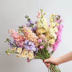 a person holding a bunch of flowers in their hand