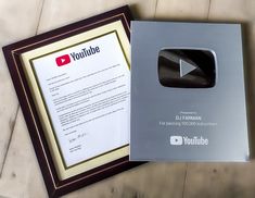 an open book with a video play button on the front and inside, sitting next to a framed letterhead