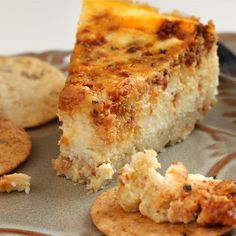 a piece of quiche on a plate with crackers