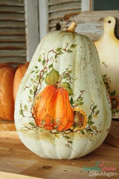 two pumpkins sitting on top of a wooden table