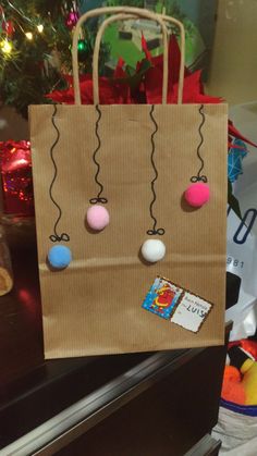 a brown paper bag with balls hanging from it