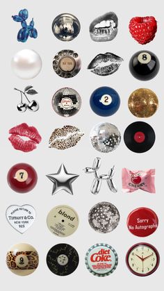 an assortment of various buttons and magnets on a white background