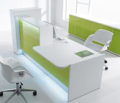 an office desk with green and white accents