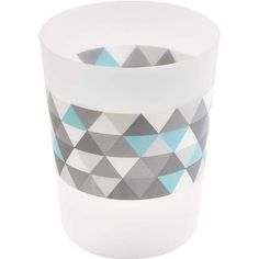 two cups with geometric designs on them sitting side by side, one is white and the other is blue