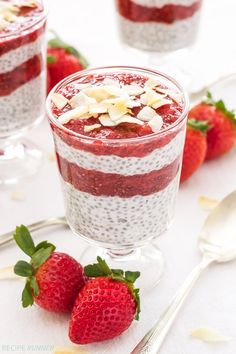 two glasses filled with chia pudding and topped with fresh strawberries on the side