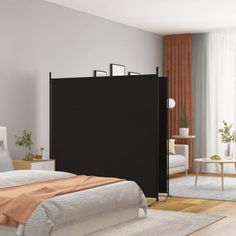 a bed room with a neatly made bed and a black screen