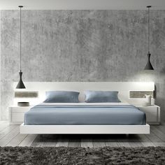 a modern bedroom with concrete walls and white furniture, including a bed that has blue sheets on it