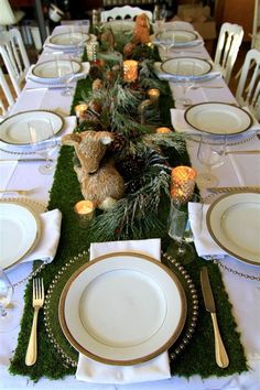 the table is set with white plates and silverware